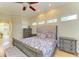 Beautiful bedroom with hardwood floors, high ceilings, a ceiling fan, and ample natural light from the multiple windows at 23136 Langdon Ave, Port Charlotte, FL 33954