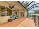 Screened patio with comfortable seating area, ceiling fan, and view of the pool at 23136 Langdon Ave, Port Charlotte, FL 33954