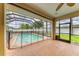 Enclosed pool area with brick-paver patio, safety fence, and a screened enclosure at 23136 Langdon Ave, Port Charlotte, FL 33954