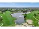 Scenic aerial view of lush golf course community with a lake and manicured landscaping at 2518 Dick Wilson Dr, Sarasota, FL 34240