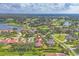Aerial view of a home in a golf course community with surrounding golf course and lakes at 2518 Dick Wilson Dr, Sarasota, FL 34240