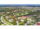 Aerial view of a neighborhood with golf course frontage and community lake at 2518 Dick Wilson Dr, Sarasota, FL 34240