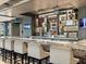 Beautiful bar with a granite countertop, display shelving, and comfortable seating at 2518 Dick Wilson Dr, Sarasota, FL 34240