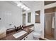 Bright bathroom featuring granite countertops, white cabinetry, and a glass enclosed shower at 2518 Dick Wilson Dr, Sarasota, FL 34240