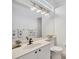 Clean bathroom featuring a vanity with sink, toilet, and a bright, white color palette at 2518 Dick Wilson Dr, Sarasota, FL 34240