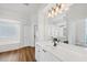 Bright primary bathroom with dual sinks, a large mirror, lots of cabinet space and a soaking tub at 2518 Dick Wilson Dr, Sarasota, FL 34240