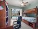 Cozy bedroom with bunk beds, a desk, and a view of the screened-in pool area at 2518 Dick Wilson Dr, Sarasota, FL 34240
