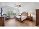 Primary bedroom suite boasts a decorative ceiling fan, and large windows allowing for plenty of natural light at 2518 Dick Wilson Dr, Sarasota, FL 34240