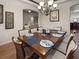 Formal dining room with hardwood floors, chandelier and open view to living room at 2518 Dick Wilson Dr, Sarasota, FL 34240