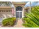 Inviting front entrance with secure gate, brick pathway and lush landscaping at 2518 Dick Wilson Dr, Sarasota, FL 34240