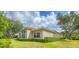 Well maintained single story house exterior with manicured lawn and mature trees at 2518 Dick Wilson Dr, Sarasota, FL 34240