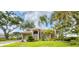 Beautifully landscaped single-story home with mature trees, tile roof and two-car garage at 2518 Dick Wilson Dr, Sarasota, FL 34240