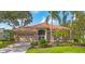 Charming single-story home features a tile roof, manicured landscaping, and a two-car garage at 2518 Dick Wilson Dr, Sarasota, FL 34240