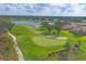 Aerial view of the lush golf course with a water hazard and manicured greens at 2518 Dick Wilson Dr, Sarasota, FL 34240