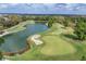 Scenic aerial view of a golf course with a pond, sand traps, and green fairways at 2518 Dick Wilson Dr, Sarasota, FL 34240