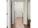 Bright hallway with wooden floors, white doors, and neutral decor creates a welcoming transition space at 2518 Dick Wilson Dr, Sarasota, FL 34240