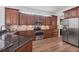 Modern kitchen with stainless steel appliances, granite countertops, and wood cabinetry at 2518 Dick Wilson Dr, Sarasota, FL 34240