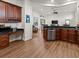 Modern kitchen with stainless steel appliances, granite countertops, and dark wood cabinetry at 2518 Dick Wilson Dr, Sarasota, FL 34240
