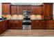 Spacious kitchen boasts wooden cabinets, stainless steel appliances, and tile backsplash at 2518 Dick Wilson Dr, Sarasota, FL 34240