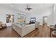 Bright living room with a ceiling fan, hardwood floors, and sliding glass doors that lead to a pool and lanai at 2518 Dick Wilson Dr, Sarasota, FL 34240