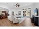 Spacious living room with ceiling fan, hardwood floors, sliding glass doors and views of the pool and lanai at 2518 Dick Wilson Dr, Sarasota, FL 34240