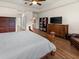 Spacious bedroom with wood floors, walk-in closets, and a large dresser at 2518 Dick Wilson Dr, Sarasota, FL 34240