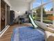 Bright playroom with large windows, built-in playhouse and slide, and a playful rug at 2518 Dick Wilson Dr, Sarasota, FL 34240
