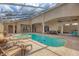 Enclosed pool and spa with brick patio, outdoor seating, and a large, covered lanai at 2518 Dick Wilson Dr, Sarasota, FL 34240