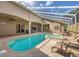 Enclosed pool and spa with brick patio, outdoor seating, and a large, covered lanai at 2518 Dick Wilson Dr, Sarasota, FL 34240