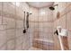 Tiled shower with a built in seat and decorative tile is the perfect way to refresh and start your day at 2518 Dick Wilson Dr, Sarasota, FL 34240