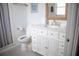This bathroom features a white vanity with ample storage and a tub with tiled walls at 3167 Pinetree St, Port Charlotte, FL 33952