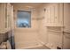 This is a well-lit bathroom with tiled walls and a white tub and shower at 3167 Pinetree St, Port Charlotte, FL 33952