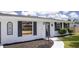 Charming home featuring a well-maintained exterior and landscaped front yard with walkway to the front door at 3167 Pinetree St, Port Charlotte, FL 33952