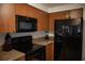 Well-lit kitchen features modern, black appliances, wood cabinets, and neutral countertops at 3167 Pinetree St, Port Charlotte, FL 33952