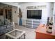Bright sunroom featuring wicker furniture, a tv, and beach themed decor at 3167 Pinetree St, Port Charlotte, FL 33952