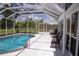Covered pool area featuring a pool, and outdoor seating, perfect for relaxation and entertainment at 3167 Pinetree St, Port Charlotte, FL 33952