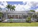Backyard pool with enclosure, surrounded by greenery, perfect for relaxation and entertainment at 3167 Pinetree St, Port Charlotte, FL 33952