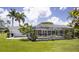 Inviting screened-in pool and backyard area featuring landscaping and plenty of space for outdoor enjoyment at 3167 Pinetree St, Port Charlotte, FL 33952