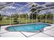 Screened-in pool with brick trim surrounded by manicured landscaping and an open view to greenery at 3167 Pinetree St, Port Charlotte, FL 33952