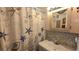 Nautical-themed bathroom with patterned shower curtain, vanity, and mosaic tile backsplash at 3333 26Th E Ave # 1023, Bradenton, FL 34208