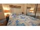 Cozy bedroom features a queen bed and mirrored closet at 3333 26Th E Ave # 1023, Bradenton, FL 34208