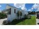 Side view of single Gathering home with manicured lawn, patio, and white siding at 3333 26Th E Ave # 1023, Bradenton, FL 34208