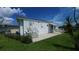 Cozy single-Gathering home featuring a concrete walkway, well-maintained lawn, and inviting entrance at 3333 26Th E Ave # 1023, Bradenton, FL 34208