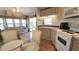 Bright, inviting living space with a well-equipped kitchen and comfortable seating area, perfect for relaxing and entertaining at 3333 26Th E Ave # 1023, Bradenton, FL 34208