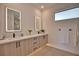 Bright bathroom with double vanity, backlit mirrors, and modern fixtures at 350 Bucknell Rd, Venice, FL 34293