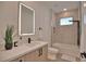 Sleek bathroom featuring modern vanity, illuminated mirror, and glass-enclosed shower at 350 Bucknell Rd, Venice, FL 34293