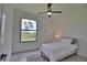 Minimalist bedroom featuring a neutral color palette, plush rug, and a view of the outdoors at 350 Bucknell Rd, Venice, FL 34293