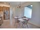 Bright dining area with stylish chandelier, modern table setting, and a view of the kitchen at 350 Bucknell Rd, Venice, FL 34293