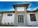 Modern home showcasing a contemporary entryway with double doors and decorative exterior lights at 350 Bucknell Rd, Venice, FL 34293