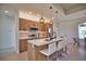 Modern kitchen with island seating, pendant lights, stainless steel appliances, and sleek wood cabinetry at 350 Bucknell Rd, Venice, FL 34293